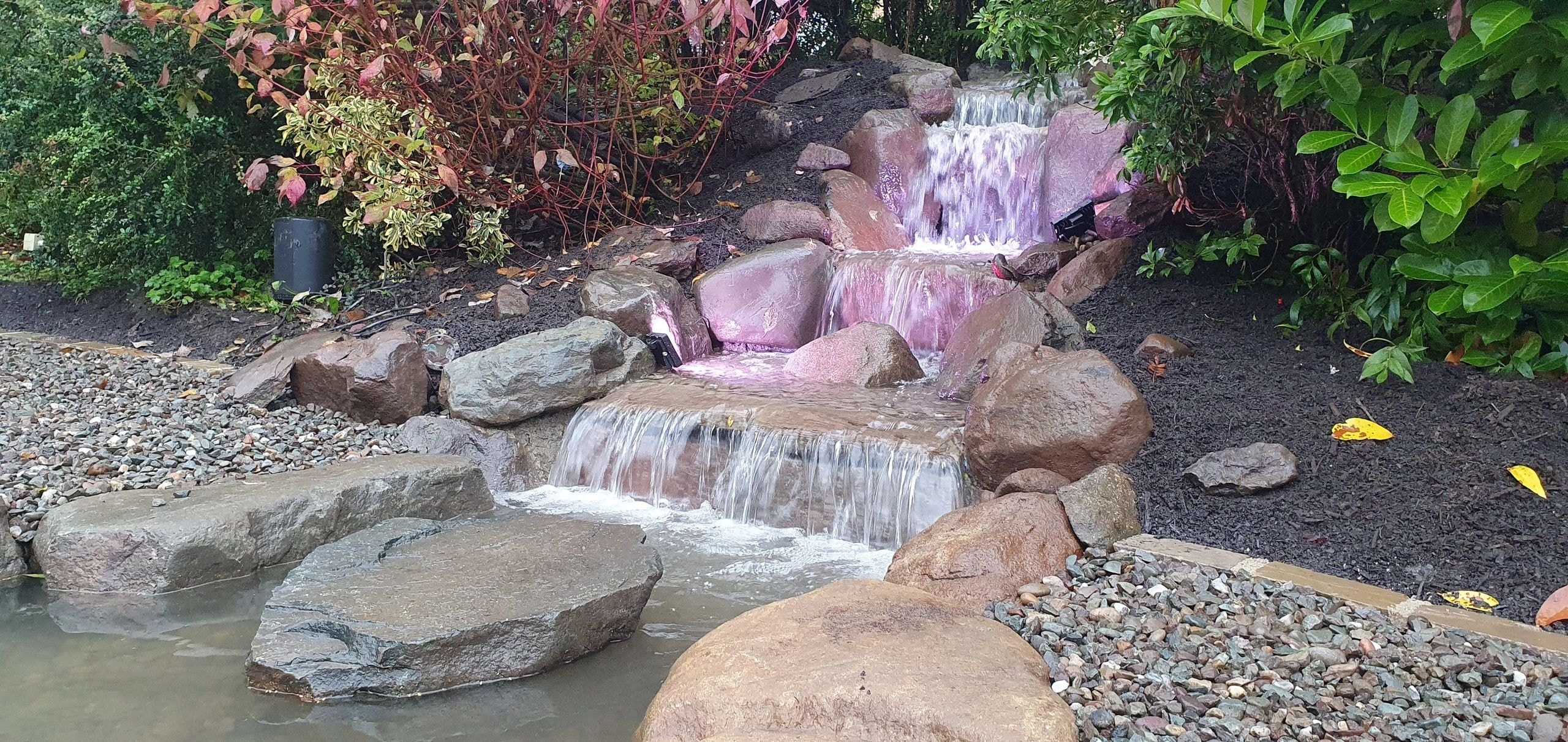 Cascading waterfall garden with rocks and plants