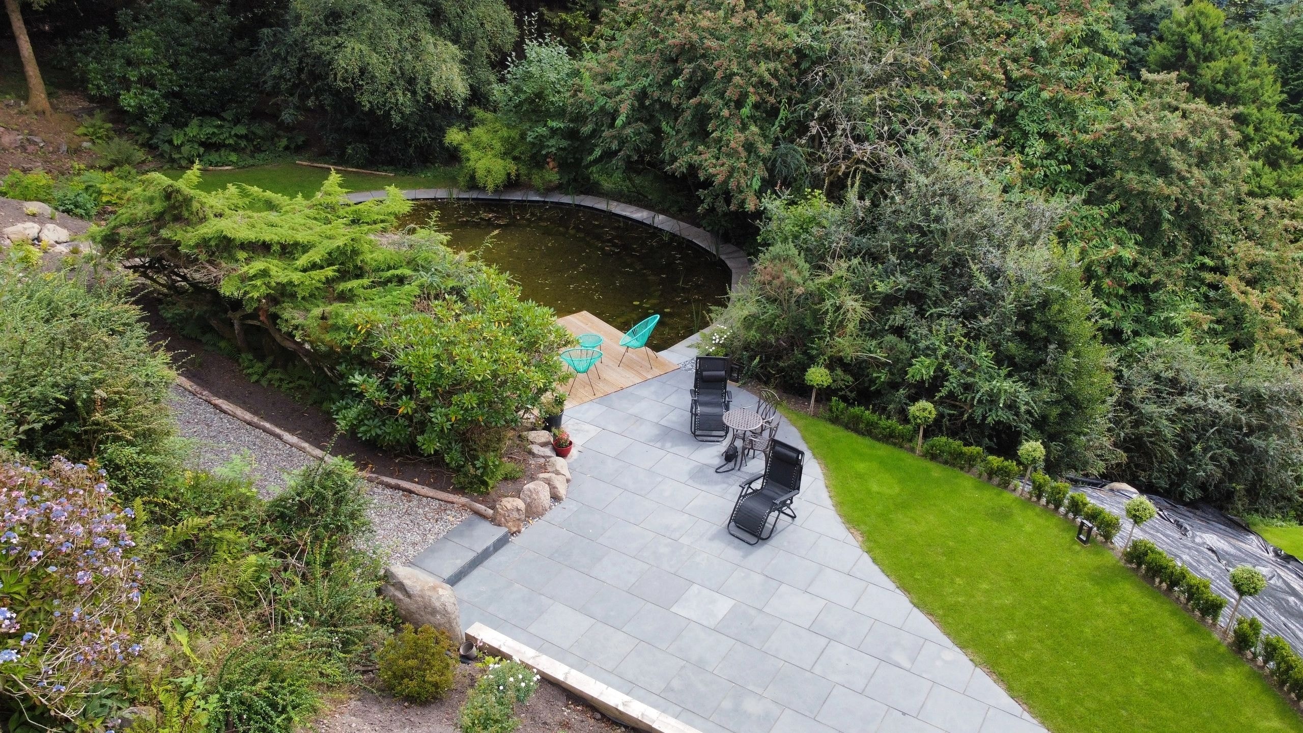 Backyard patio overlooking pond and forest